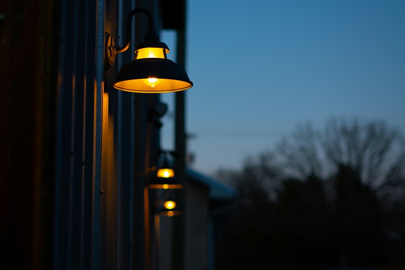 A couple of lights that are on the side of a building A couple of lights that are on the side of a building
