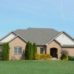 A suburban brick house with a well-kept lawn