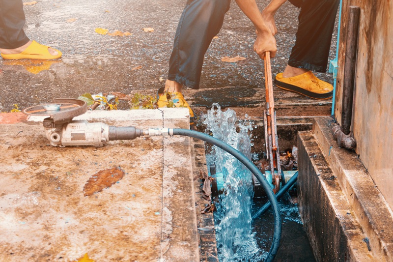 Plumber working repair the broken pipe with Adjustable Wrench