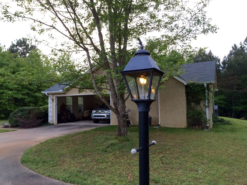 Traditional Black Outdoor Lamp Post in Front of Suburban Garage
