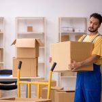 Young male contractor doing home relocation