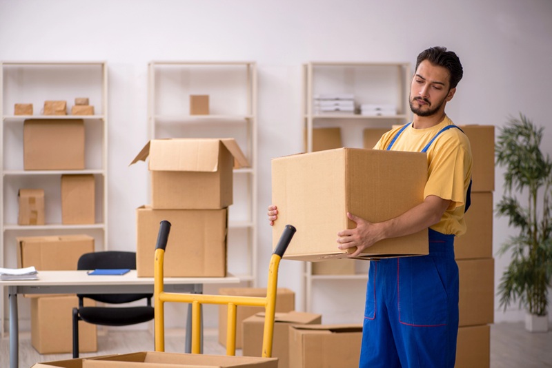 Young male contractor doing home relocation Young male contractor doing home relocation