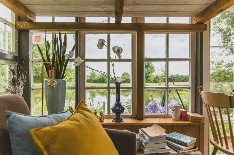 a living room filled with furniture and a large window a living room filled with furniture and a large window