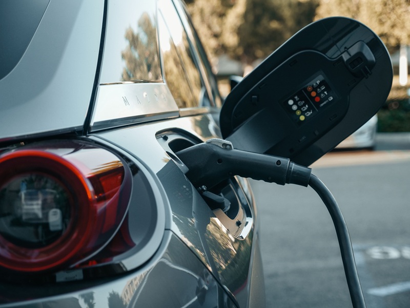Close-up of an electric vehicle being charged, highlighting modern clean energy technology Close-up of an electric vehicle being charged, highlighting modern clean energy technology