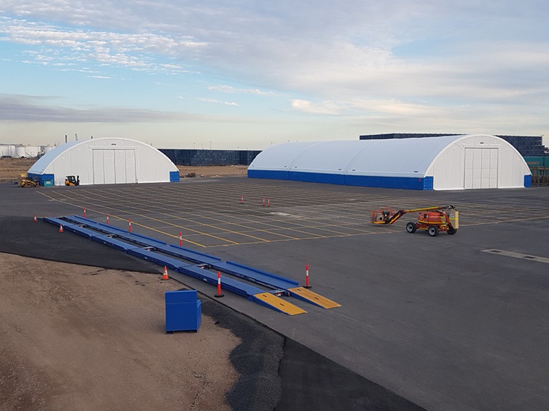 Large Industrial Container Dome Shelters on Asphalt Site Large Industrial Container Dome Shelters on Asphalt Site