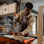 Skilled Craftsman Drilling Wood in Modern Workshop