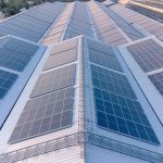 Solar cells panel installed on the roof of a large building
