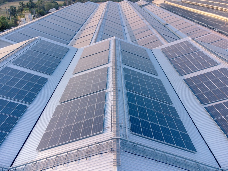 Solar cells panel installed on the roof of a large building Solar cells panel installed on the roof of a large building