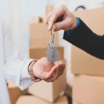 Close up of realtor giving keys from house