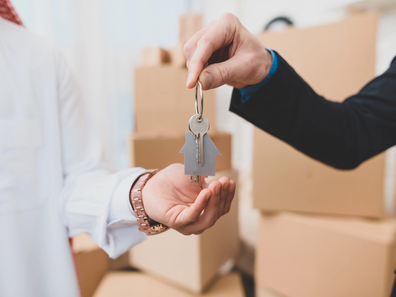 Close up of realtor giving keys from house Close up of realtor giving keys from house