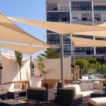 Custom shade sails over a backyard patio in Melbourne with marine-grade 316 stainless steel fittings