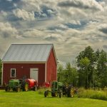 Small farm shed with machinery outside