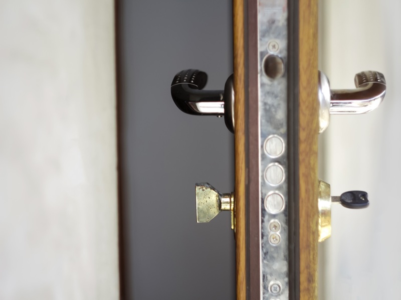Defocus half opened door to a living room. Door handle, door loc Defocus half opened door to a living room. Door handle, door loc