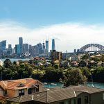 a view of a city with a bridge in the background